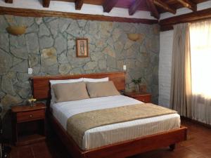Postel nebo postele na pokoji v ubytování Hotel y Hosteria Natabuela