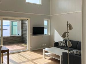 a living room with a couch and a tv at 6 person holiday home in Dyrvik in Dyrvik