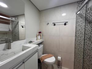 a bathroom with a toilet and a sink and a shower at AP Smart Center in Campinas