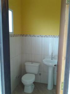 a bathroom with a toilet and a sink at Maresias Flats Unidade I in Maresias +14 photos
