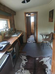 a dirty kitchen with a sink and a table at Edens retreat in Upper Moutere