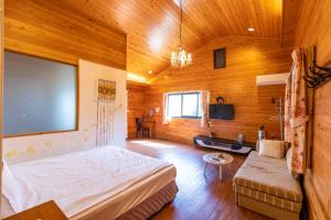 a bedroom with a bed and a flat screen tv at Walk Cloud Bed and Breakfast in Meishan