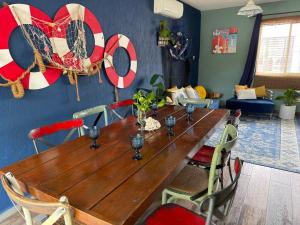 a wooden table in a living room with a tableablish at Marineros Vallarta in Puerto Vallarta