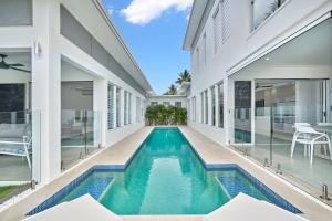 a swimming pool in the middle of a house at Deja View Trinity Beach in Trinity Beach