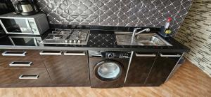 a kitchen with a washing machine and a sink at Appartement stylia 2 in Agadir