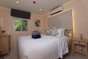 a bedroom with a white bed with towels on it at Woodbridge Property at Karon Butterfly in Karon Beach +143 photos
