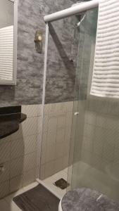 a shower with a glass door in a bathroom at Flat da Luz in Guarabira