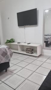 a living room with a flat screen tv on the wall at Flat da Luz in Guarabira