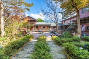 a backyard with a stone pathway leading to a house at Walk Cloud Bed and Breakfast in Meishan
