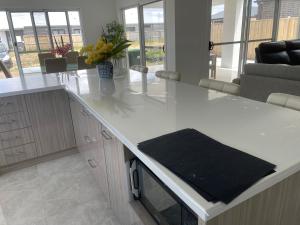 a kitchen with a white counter with flowers on it at Ensuite room in Mount Duneed in Mount Duneed