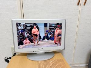 a computer monitor sitting on a desk with men on it at ハイツ緑ヶ丘103 in Nagasaki +8 photos