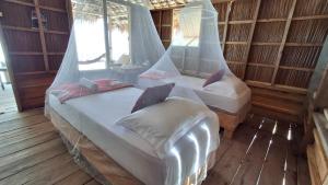 a room with two beds and a couch in it at Yefkabu Homestay in Jef Tsiep