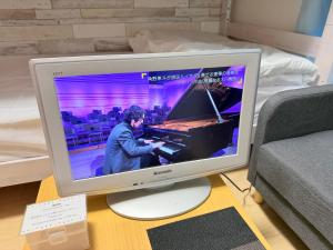 a computer monitor sitting on a table with a keyboard at ハイツ緑ヶ丘206 in Nagasaki