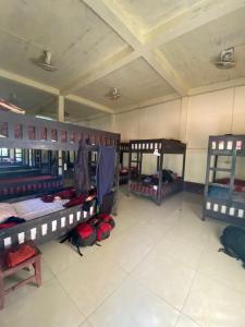 a room with three bunk beds in a room at Dormitory Hostel Cam Uo in Nongkhiaw