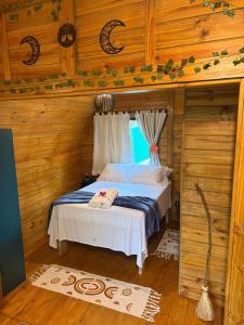a bedroom with a bed in a wooden cabin at Cabana Rota do Vinho in São Roque +96 photos
