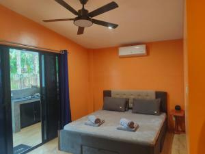 a bedroom with a bed and a ceiling fan at Orange House in San Juan