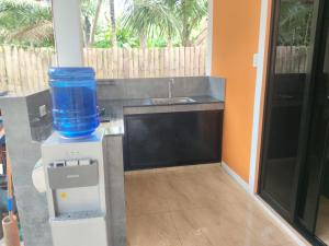 a kitchen with a water cooler and a sink at Orange House in San Juan