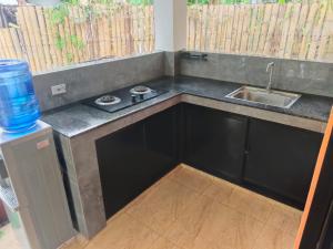 a kitchen with a sink and a counter top at Orange House in San Juan