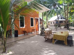 an orange house with a table and chairs in front of it at Orange House in San Juan