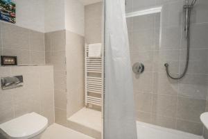 a bathroom with a shower with a toilet and a sink at 1 Hazeldene in Salcombe +17 photos