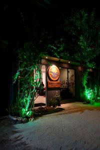 a restaurant with a sign on the front of it at night at Havaa Inn Dhangethi in Dhangethi