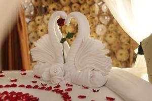 two white swans sitting on top of a wedding cake at The Tirta Sari Villas in Tegalalang +42 photos