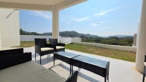 a patio with a table and chairs and a view at Casa Chaue in Tangolunda