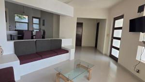 a living room with a couch and a glass table at Casa Chaue in Tangolunda