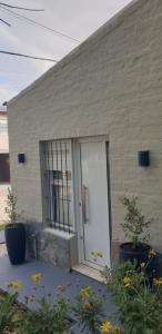 a door of a building with flowers in front of it at Mini Loft in Tandil