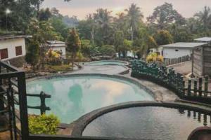 a view of a swimming pool at a resort at Wisma Belerang Kalianda Lampung RedPartner in Kalianda