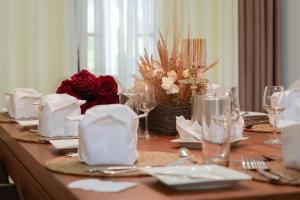 a table with red roses and white napkins and glasses at Sandul Villa in Beruwala +23 photos