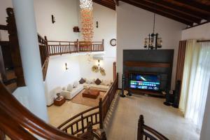 a living room with a couch and a television at Sandul Villa in Beruwala