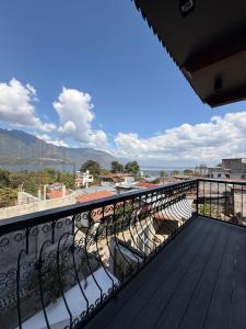 a balcony with chairs and a view of the mountains at Casa Don Cristóbal Hotel y Restaurante Boutique in San Juan La Laguna