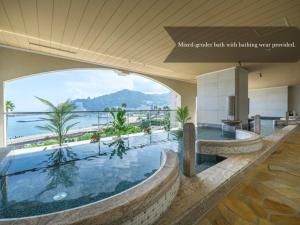 a large swimming pool with a view of the ocean at La Vista Atami Terrace in Atami