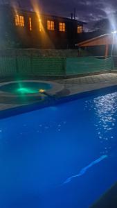 a swimming pool at night with blue lights at Panul Ovalle in Panulcillo