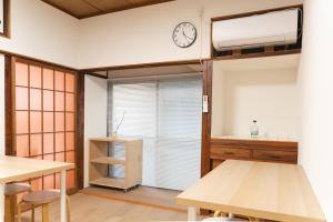 a room with a bunk bed with a clock on the wall at one space 泊まれるコワーキングスペース in Kawatana