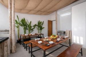 a dining room with a table and chairs and plants at E Stay Boutique in Vung Tau