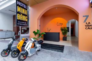 two scooters parked in front of a building at E Stay Boutique in Vung Tau