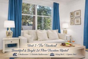 a living room with a white couch and a window at Designer condo w oceanfront & walk to Worth Ave in Palm Beach +29 photos