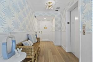 a hallway with a couch and a table in a room at Designer condo w oceanfront & walk to Worth Ave in Palm Beach