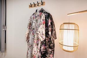 a dress hanging on a wall next to a bird cage at Ryokan Stay in Gangneung +15 photos