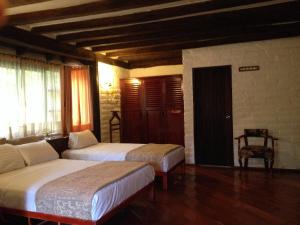 Postel nebo postele na pokoji v ubytování Hotel y Hosteria Natabuela