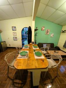 a large wooden table with chairs in a room at Casa Cacao in Lanquín