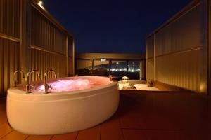a bath tub on the balcony of a building at Business Resort Kyuan in Oita