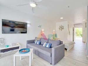 a living room with a couch and a bed at Studio à Anse Marcel - FR-1-734-86 in Marigot