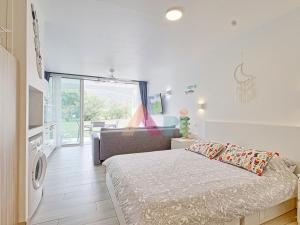 a bedroom with a bed and a washing machine at Studio à Anse Marcel - FR-1-734-86 in Marigot