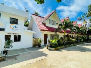 a white building with a red roof at Castle Rock Boracay in Boracay