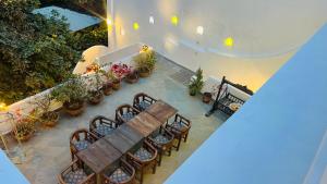 an overhead view of a patio with benches and potted plants at Mosaics Guest House in Jaipur +66 photos