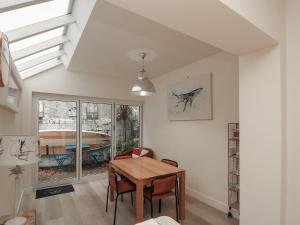 a dining room with a table and a window at Full Deck in Dartmouth