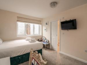 a bedroom with a bed and a flat screen tv at Full Deck in Dartmouth